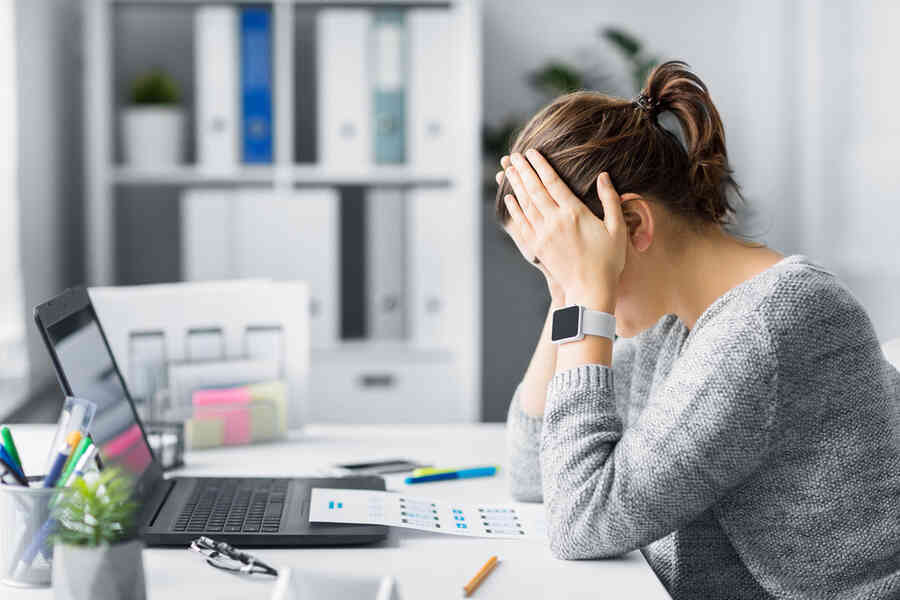 A woman looking stressed at work